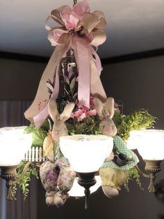 a chandelier decorated with flowers and stuffed animals