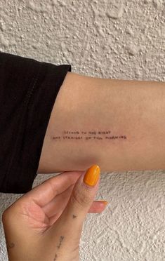 a woman's arm with a quote on it