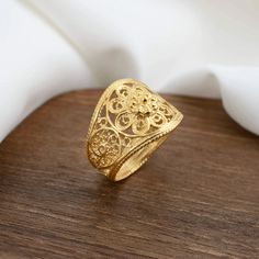 Elevate Your Style with the Gold-Plated Sterling Silver Filigree Art Lace Flower Cocktail Ring A Statement of Elegance and Femininity Elevate your style with the Gold-Plated Sterling Silver Filigree Art Lace Flower Cocktail Ring. This striking statement ring is meticulously handcrafted from 925 sterling silver and boasts luxurious gold plating. The intricate filigree art is adorned with delicate lace flower detailing, adding a touch of femininity and timeless elegance to your look. Perfectly Siz Gold Bohemian Filigree Rings, Bohemian Gold Filigree Rings, Bohemian Gold Filigree Ring For Wedding, Gold Bohemian Filigree Wedding Ring, Bohemian Gold Filigree Wedding Ring, Silver Cocktail, Sterling Silver Filigree, Lace Flower, Filigree Ring