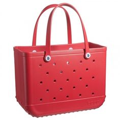 a red tote bag with holes on the front and side, sitting against a white background