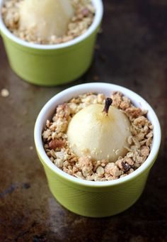 two green cups filled with food on top of a table