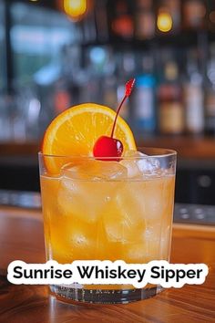 an orange drink sitting on top of a wooden table