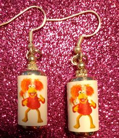 Dance your cares away while wearing these fun Fraggle Rock/ Red Fraggle in a can retro 80s Earrings! An excellent gift for someone who was obsessed with Fraggle Rock muppets! Small in size- less than 1 inch tall and less than 1 inch wide. They are lightweight and great quality. Made with sterling 925 silver hooks.  They come with a gift bag and are made with pure silver hooks. Safe for sensitive ears- lead and nickel free. Fun Nickel-free Metal Jewelry, Playful Red Nickel-free Jewelry, Quirky Red Jewelry For Gifts, Retro Sterling Silver Earrings For Gift, Retro Sterling Silver Earrings Gift, Fun Red Adjustable Earrings, Funky Red Handmade Jewelry, Funky Adjustable Jewelry For Gifts, Funky Adjustable Jewelry For Gift