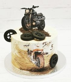 a cake decorated with an atv and wheels