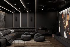 a living room filled with lots of furniture and a large screen on the wall behind it