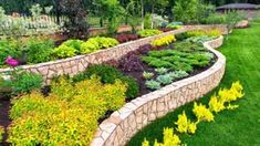 a garden filled with lots of different types of flowers and plants on top of green grass