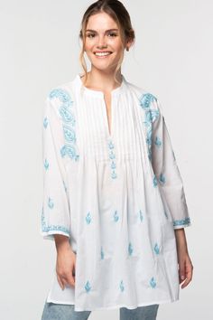 Our Kamalika Tunic is hand embroidered by women artisans in Northern India in the shadow-work style known as "Chikankari". Chikankari is a delicate and artfully done hand embroidery technique that women in this region have been doing for generations.  Available in two sizes, S/M and L/XL, this beautiful 100% cotton tunic is designed for a comfortable and elegant fit. Traditional Tops With Tonal Embroidery For Festive Occasions, Bohemian Chikankari Embroidered Tunic Top, Blue Embroidered Festival Kurta, Blue Embroidered Kurta For Festival, Festival Cotton Embroidered Fabric, Festive Traditional Tops With Tonal Embroidery, Multicolor Embroidered Folk Fabric, Traditional White Chikankari Embroidered Top, Bohemian Cotton Fabric With Resham Embroidery