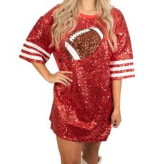 a woman wearing a red sequin football jersey and white boots with her hands on her hips