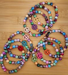 Peace sign multi color stretch stack boho bead bracelets - pick your favorite bohemian color.  Each bracelet is 7 1/2 inches long.  Created by Kelly in the USA! Please do not over stretch, may result in breakage.  Never leave small children unattended with items containing small pieces, potential choking hazard.  Beads may change colors over time if worn in water or while applying products to the skin such as lotions. Check out my Etsy store for bracelets and more Kellyanndesigsgifts.etsy.com Bohemian Multicolor Bracelets For Summer, Hippie Colorful Beaded Summer Bracelets, Bohemian Multicolor Stretch Bracelet For Beach, Colorful Beaded Bohemian Stretch Bracelet, Bohemian Wooden Beads Stretch Bracelet, Colorful Bohemian Beaded Stretch Bracelet, Hippie Hand-strung Friendship Bracelets With Round Beads, Hippie Hand-strung Beaded Bracelets For Festival, Hand-strung Hippie Friendship Bracelet With Round Beads