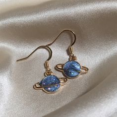 Size: 1.2x1.6x0.2cm  Weight: 30g (pendant only) Introducing the 'Blue Planet' earrings by J&K Jewellery. If you love all things space then these are the perfect earrings for you! Our earrings are all hypoallergenic that comes with a rubber back and each space pendants are made of high quality alloy. If you love all things planets, moon and stars then these are the one for you! These unique earrings will grasp everyone's eye. ↬ Hypoallergenic gold plated 304 stainless steel hooks ↬ All earrings c Celestial Style Drop Earrings As Gift, Celestial Drop Earrings Gift, Celestial Single Earring Jewelry Gift, Celestial Single Earring Jewelry For Gift, Rose Gold Celestial Earrings For Gift, Celestial Style Hypoallergenic Drop Earrings, Trendy Blue Sterling Silver Earrings, Trendy Blue Sterling Silver Jewelry, Blue Pendant Earrings For Gift