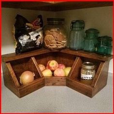 a corner shelf filled with apples and jars