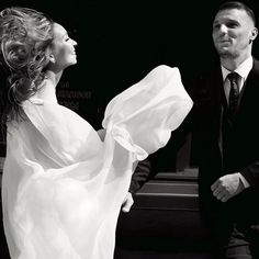 black and white photograph of a man and woman dressed in formal wear, standing next to each other