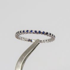 Vintage Sterling Silver Round cut Blue Sapphire Eternity Band Ring ...Marked 925...Total of weights 1.2grams...Size 8...Measure of Face 1.9MM...It's in very good condition. Blue Round Jewelry With Channel Set, Blue Sterling Silver Jewelry Channel Set, Blue Sterling Silver Jewelry With Channel Set, Blue Sterling Silver Rings With Channel Set, Blue Eternity Band For Promise, Blue Channel Set Jewelry With Round Band, Silver Sapphire Eternity Band, Elegant Blue Hypoallergenic Rings, Blue Sterling Silver Stackable Rings With Round Band