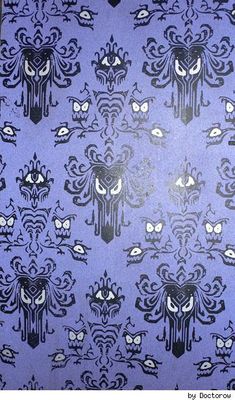 a blue and black wallpaper with an ornate design on it's side,