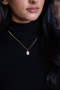 The Mini Ek Onkar Pendant necklace for women is a beautiful reminder of our source of strength and love. Made in 925 Sterling Silver that is layered in 18kt gold, with an enameled pendant and a polished chain, it is a wonderful addition to every moment. *Pendant Size: 14mm x 10.5mm *Chain length: 16"-18" adjustable *Material: Made in 925 Sterling Silver then layered in 18kt gold. *Capture shows the companion Mini Khanda Necklace design. Same size as Mini Ek Onkar necklace. 14k Gold Oval Pendant Charm Necklace For Gift, Oval Pendant Necklaces, Hallmarked Initial Pendant Jewelry, Silver Oval Pendant Charm Necklace In Gold Plated, Spiritual 14k Gold Charm Necklaces, Gift Oval Pendant Necklace Tarnish Resistant, Tarnish Resistant Oval Pendant Necklace As Gift, Tarnish Resistant Oval Pendant Necklace For Gift, Medallion Necklaces With Charms