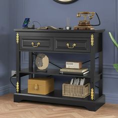 a black table with drawers and a clock above it