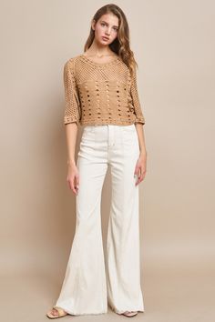 This Short Sleeve Cropped Knit Top is the perfect addition to your wardrobe for nights out and concerts. The western style adds a unique touch, while the oversized and cropped fit allows for versatility in dressing it up or down. Stay on-trend and comfortable with this must-have top. Chic Beige Cropped Sweater For Spring, Knit Crop Top For Day Out In Fall, Cropped Beige Sweater For Spring, Chic Knit Crop Top For Fall, Chic Cropped Cotton Sweater, Trendy Fall Cropped Sweater, Trendy Knit Crop Top Sweater, Chic Cotton Cropped Sweater With Crew Neck, Chic Knit Cropped Sweater For Spring