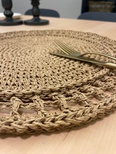 a close up of a place mat on a table with two forks and a knife