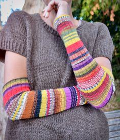 a woman with her arm knitted in multi - colored yarn