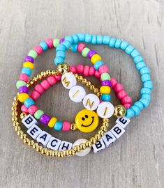 Beach Babe Bracelet Stack ☀️😊 Sand. Salt. Sea. Made with 4mm seed beads, mini square letters, gold letter beads, 18k gold spacers, pearl, yellow smiley The perfect bracelets for your little beach babe 🐚🌴 If you would like another word or color, please put in Personalization Section* and we will message you if we have any questions.  CARING TIPS FOR YOUR JEWELRY ⭐️Treat and store with care. ⭐️ For longevity, avoid exposing your jewelry to water. ⭐️ Avoid having direct contact with lotions, per Adjustable Pink Holiday Jewelry, Adjustable Pink Jewelry For Holiday, Personalized Gold Friendship Bracelets For Beach, Adjustable Multicolor Bracelet For Holiday, Adjustable Multicolor Bracelets For Holiday, Fun Vacation Jewelry With Letter Beads, Fun Letter Beads Jewelry For Vacation, Adjustable Multicolor Stretch Bracelet For Holidays, Adjustable Multicolor Jewelry For Holiday