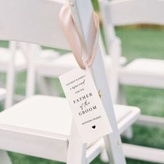 a white chair with a pink bow tied to it's back and the name tag on it