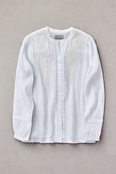 Like a spring song, the Celia embroidered shirt will give your warm-weather wardrobe a lovely lift. Enchanting folk-motif embroidery in deep shades of indigo brings high-contrast appeal to this breezy linen button front that offers pretty features at every turn. Ruffles at the collar and hem and a pleated placket and cuff lend just the right touches. A pleated back yoke detail and faux mother of pearl buttons finish this lightweight, easy-fitting style. Pair with cropped pants for an irresistibl Embroidered Linen Shirt, Pretty Features, Folk Motif, Motif Embroidery, Spring Song, Sheepskin Coat, Embroidered Linen, Men's Coats & Jackets, High Contrast