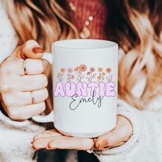 a woman holding a white coffee mug with the words,'anytime'on it