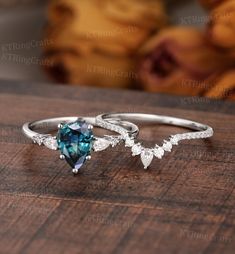 two rings with blue and white diamonds on top of a wooden table next to bananas