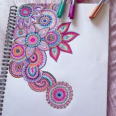 a spiral notebook with an inspirational quote written on the cover and colorful flowers in the middle