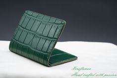 This credit card holder is made of genuine alligator leather and Alran goat leather. The alligator leather is tanned in the highest quality and finished in a very nice green color. It's free from decoloration. The Alran goat leather is well known as one of the best goat leather all over the world. It has a soft touch feeling and deluxe color. DESIGN: This wallet has 1 card slot on the outside for your frequently used card. + 4 card slots on the inside. + 2 hidden slots for folded cash or ID card Green Luxury Card Holder With Interior Slots, Luxury Green Wallets With Card Slots, Elegant Green Bifold Card Holder, Elegant Green Rectangular Card Holder, Green Leather Luxury Card Holder, Luxury Green Leather Card Holder, Green Leather Card Holder For Formal Use, Green Rectangular Business Wallet, Wallet Minimalist