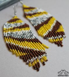 These shining yellow evening earrings are made of high-quality Czech beads and strong synthetic thread. They are elegant, fashionable, and highly versatile, suitable for everyday wear. Features: Sterling silver components Color: Yellow, brown, silver. This item is currently in stock. You must be completely satisfied. If you find merchandise unsatisfactory for any reason, return it within 10 days and your money will be refunded without questions. More beaded earrings http://etsy.me/2ycItdb Gerdan Red Chandelier, Animal Print Earrings, Long Gold Earrings, Fringe Earrings, Seed Bead Earrings, Czech Beads, Gorgeous Earrings, Zebra Print, Chandelier Earrings