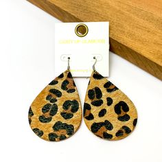 Large leopard print drop earrings.Pictured on a white background with a wood piece in the top right corner. Trendy Leopard Print Dangle Earrings, Trendy Leopard Print Dangle Jewelry, Handmade Leopard Print Earrings, Trendy Leopard Print Earrings As Gift, Giddy Up Glamour, Large Size, Leopard Print, Drop Earrings