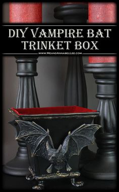 the vampire bat trinket box is shown with red candles in front of it