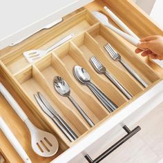 a drawer with utensils and spoons in it