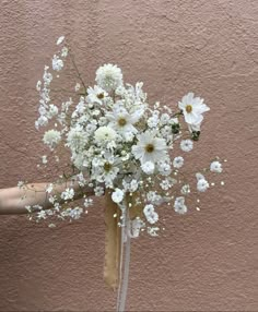 a person holding a bouquet of white flowers