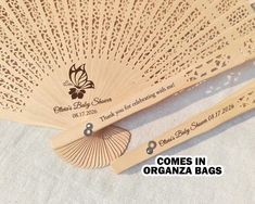 two wooden fans sitting next to each other