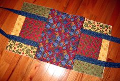 a patchwork table runner on the floor