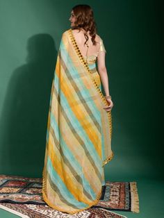 Looking for a stunning, versatile saree that you can wear to any event, be it a festival or a casual occasion? Look no further than our amazing multicolor lehriya print chiffon festival wear saree! Made from smooth chiffon material and featuring a beautiful lehriya print, this saree also comes with exquisite zari work and a double-line mirror outing border. Plus, the golden plain blouse is embellished with a smooth material. The 5.50-meter long saree and stitched 1.00-meter blouse. Multicolor Traditional Wear With Sheer Dupatta For Puja, Unstitched Multicolor Suit With Sheer Dupatta For Navratri, Multicolor Unstitched Suit With Sheer Dupatta For Navratri, Multicolor Unstitched Suit With Sheer Dupatta For Wedding, Multicolor Cotton Silk Sets With Cutdana, Multicolor Cotton Silk Sets With Cutdana Details, Multicolor Cotton Silk Set With Cutdana, Multicolor Unstitched Saree Suit With Sheer Dupatta, Multicolor Georgette Blouse Piece For Puja