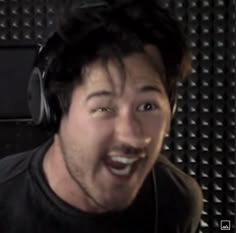 a man wearing headphones and making a goofy face