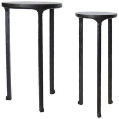 two black metal tables sitting next to each other