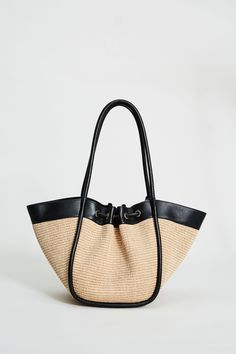 Step into Spring in style with our exclusive Raffia Tote Bag. Handcrafted in Italy, our chic, drawstring handbag is designed in the finest raffia fabric with contrasting Nappa Leather trim & gold handwear. With so many essentials to carry these days, this handbag puts the fashion in function with its knot Closure & ruched detailing. Elie Tahari Exclusive Raffia & Italian Leather Tote Bag with Gold Stud accents & a drawstring Knot Closure Measurements: 10" L, 20" Width, 12" Opening; Base 8"x6" Ma Pretty Handbags, Drawstring Handbag, Raffia Tote Bag, Jute Tote Bags, Jute Totes, Elie Tahari, Black Sand, Crochet Bags, Gold Stud