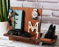 a wooden desk organizer with personal items on it