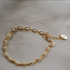 Our Pippa Pearl Bracelet is dainty + modern! What do we love about it? The tiny pearl accents add just a touch of traditional style in a modern way! This bracelet is perfect for any bridal event but can also be worn any time of the year or for any occasion which makes this the perfect gift! BRACELET FEATURES Materials: Brass, 14K Gold, Rhodium, Faux Pearl Finish: Choice of Yellow Gold or Rhodium Plating Dimensions: 6.5" with a 2" extender (can be worn up to 8.5") 14K gold-filled or sterling silv Elegant Metal Charm Bracelet With Delicate Chain, Elegant White Pearl Bracelet With Adjustable Chain, Classic Pearl Bracelets With Adjustable Chain, Classic Adjustable Chain Bracelet With Pearl Charm, Elegant Adjustable Chain Bracelet With Pearl Charm, Elegant Beaded Bracelets With Adjustable Chain, Elegant Charm Bracelet With Adjustable Chain, Elegant Adjustable Pearl Charm Chain Bracelet, Pearl White Bracelets With Pearl Charm For Bridesmaids