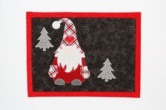 a patchwork santa clause with trees on it