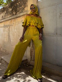 Our Hana Pants in Ayel Olive is the perfect addition to your wardrobe. These pants feature an elasticized waistline, side pockets, and wide legs, offering both style and comfort. Complete the look with our matching Wairu Top for effortless coordination. High-waisted pants Side pockets Wide-legged Lightly elasticized waistline Handcrafted in our small atelier in Dakar, Senegal Height customization available 100% Polyester Jacquard SIZINGSizes XS to 3XL CAREMachine wash cold with similar colors. H Yellow Wide Leg Harem Pants For Spring, Yellow Relaxed Fit Wide Leg Pants, Bohemian Wide-leg Pants With Tie Waist, Green Bohemian Wide Leg Full-length Pants, Luxury Bohemian Wide-leg Pants, Luxury Spring Wide-leg Parachute Pants, Yellow Stretch Wide-leg Pants, Yellow Wide-leg Pants With Elastic Waistband, Yellow Wide-leg Harem Pants With Elastic Waistband