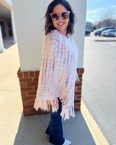 Wrap yourself in the cozy comfort of our Jane Fringe Poncho. It’s a stunning cable knit cape, accented with a vibrant multi-color fringe detail that unarguably stands out. This pullover is not just a stylish accessory, it's an experience of unmatched warmth and comfort. The poncho features a loose fit design to keep you at ease throughout the day, making it an excellent choice for those chilly days and cool nights. The multi-color fringe detailing adds a playful pop of color to the subdued cable One Size Knit Poncho With Fringe, Spring Fringe Poncho One Size, Casual Spring Poncho With Tassels, Spring Poncho One Size With Tassels, Spring Poncho With Tassels One Size, One Size Spring Poncho With Tassels, Spring Poncho With Tassels, One Size Tassel Poncho For Spring, Trendy One-size Poncho For Spring