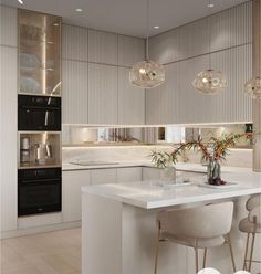 a modern kitchen with white counter tops and bar stools