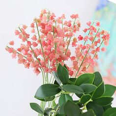 a vase filled with pink flowers on top of a table