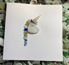 I had a lightbulb moment while out walking with my Westie and had to turn and get home to make the idea  Who doesn't love a bit of magic and fantasy and this is where my unicorn card fits in.  Made from beautiful seaglass from Ireland's Wild Atlantic Way, the multicolored glass on the mane are tiny pieces that lie buried under rocks at the beach  Measuring 6 x 6 this stunning card comes with matching envelope and cellophane  Make someone's birthday with this unique, magical card  Your card will Unicorn Birthday Card, Lightbulb Moment, Sea Glass Artwork, Unicorn Birthday Cards, Beach Glass Crafts, Unicorn Card, Wild Atlantic Way, Girl Birthday Cards