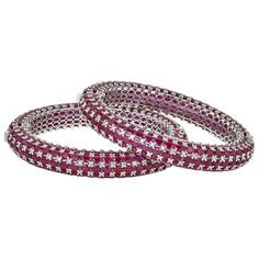 Elegant Ruby and diamond bangles with over 100ct of Rubies between the two. The craftsmanship is beautiful the closure is sleek and isn't noticeable. This is a product that can be collaborated with many styles. Luxury Ruby Bangle As A Gift, Luxury Red Ruby Bangle, Luxury Ruby Bangle For Anniversary, Luxury Hand Set Round Bangle, Luxury Cubic Zirconia Round Bangle, Flexible Luxury Bangle For Anniversary, Luxury Flexible Bangle For Anniversary, Luxury Stackable Bangle For Formal Occasions, Luxury Stackable Bangle For Formal Events